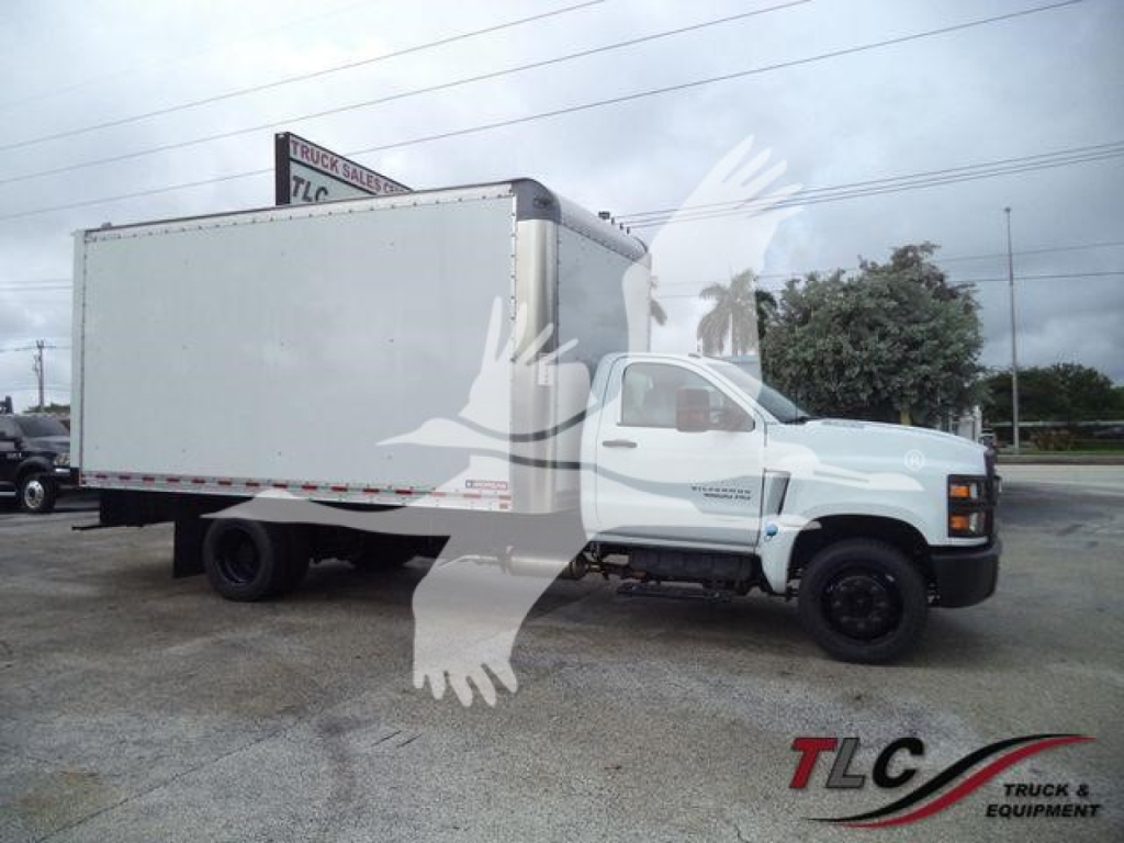 Chevrolet Silverado 6500HD box truck in side view showing cargo box and cab with white paint