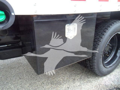 Trucks background showing toolbox with square handle and wheel; part of a 2023 Chevrolet Silverado 6500HD listing.
