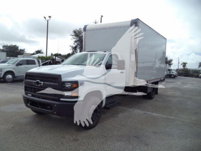 Chevrolet Silverado 6500HD box truck viewed from front-left in dealership lot.