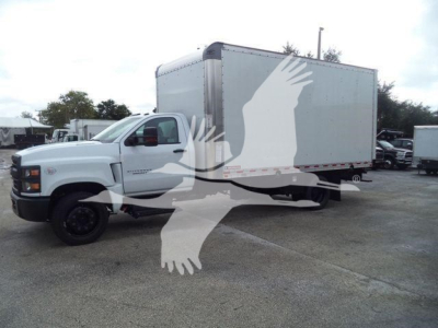 Truck showing a white Chevrolet Silverado 6500HD box truck with a large cargo box attached to a cab and chassis.