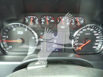 Truck dashboard displaying gauges including rpm, speedometer, and digital display reading 0 mph and gear selector P R N D L; shows Chevy Silverado 6500HD stock photo.