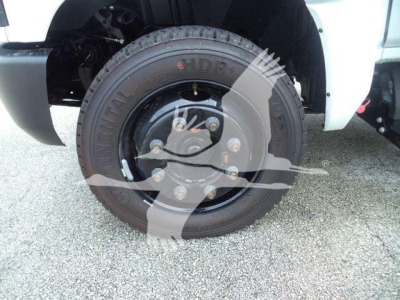 Front wheel of a 2023 Chevrolet Silverado 6500HD with tire and hub visible in the wheel well.