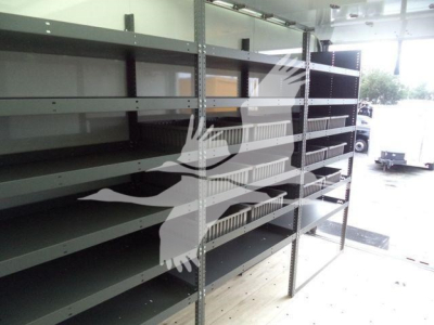 Storage shelves on a truck interior showing metal shelving units with multiple tiers in a cargo area.