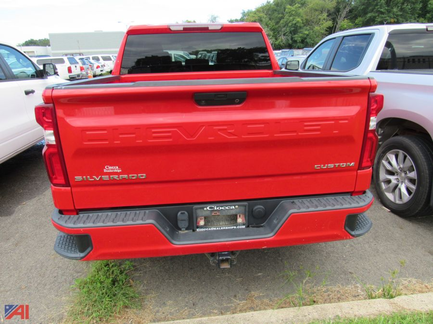 Chevrolet Silverado 1500 Limited rear view showing taillights, tailgate with CHEVROLET lettering, Custom badge, and bumper with hitch receiver.
