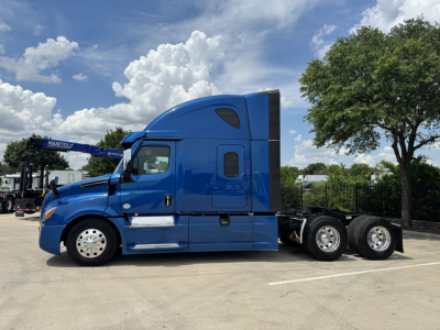 Freightliner Cascadia 126 sleeper cab side view showing blue exterior, chrome mirrors, aerodynamic fairing, and dual rear axles.