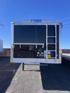 Stoughton grain trailer rear view showing hopper access ladder and inspection doors.