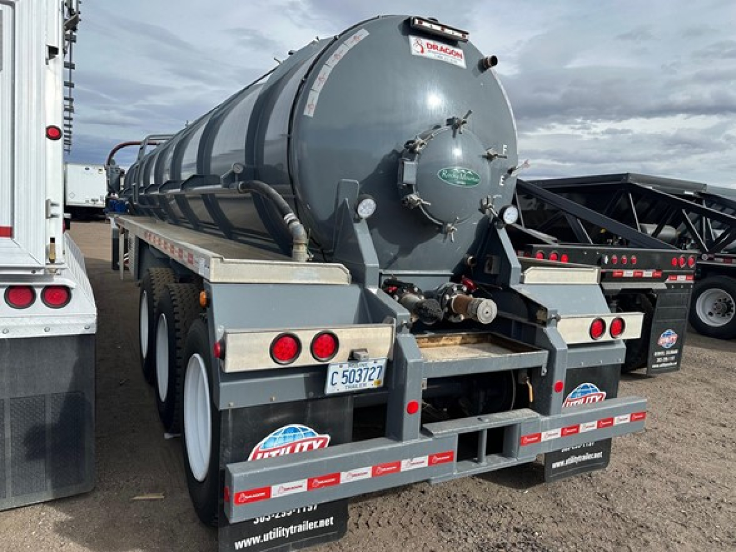 Vacuum tanker trailer rear view showing cylindrical tank, mud flaps, and rear lights.