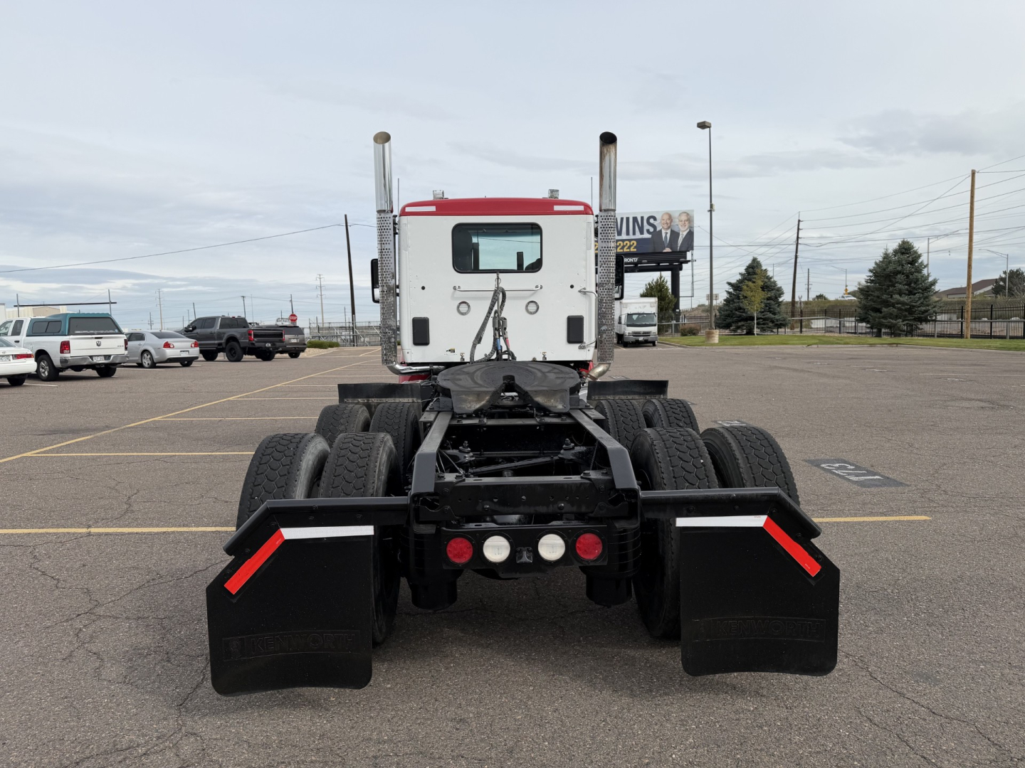Kenworth T880 tractor rear view showing dual rear axles and mud flaps.