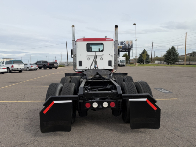 Kenworth T880 tractor rear view showing dual rear axles and mud flaps.