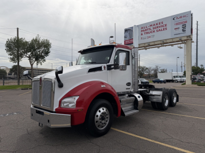 Kenworth T880 conventional daycab truck in white and red with dual rear axles and a chrome bumper, VIN 1XKZDP9X0PJ249346, stock 0632143, used.