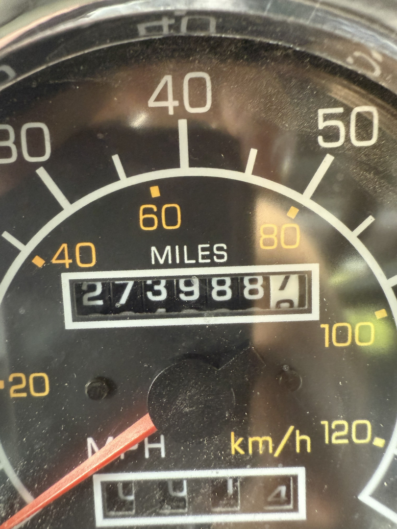 Dashboard/odometer visible on Kenworth T800 truck showing 27,398.7 miles and speedometer up to 120 km/h.