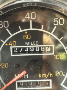Dashboard/odometer visible on Kenworth T800 truck showing 27,398.7 miles and speedometer up to 120 km/h.