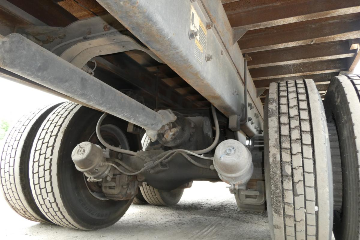 Mack RD690S chassis underside showing leaf springs, rear axle, differential, and dual rear wheels with tires.