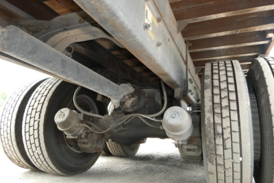 Mack RD690S chassis underside showing leaf springs, rear axle, differential, and dual rear wheels with tires.