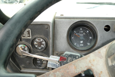 Mack RD690S dashboard and gauge cluster showing RPM gauge and various indicators.