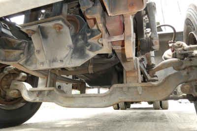 Mack RD690S underside view showing front axle, suspension, and drive components.