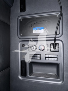 Cab interior console showing storage bin, control dials, and USB-C/aux port on Freightliner Cascadia 126 dash