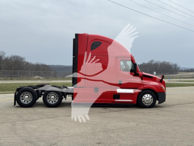 Truck side view showing a red 2023 Freightliner Cascadia 126 tractor with sleeper cab and dual rear axles, on a highway