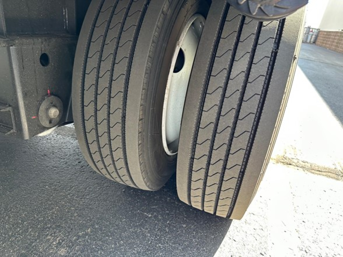 Trailer rear dual tires with wheel rims and lower chassis visible.