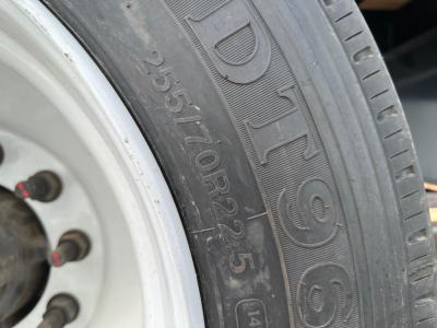 Close-up of trailer tire with embossed markings: 265/70R22.5 and DURA HOUL (?) text visible on the sidewall.