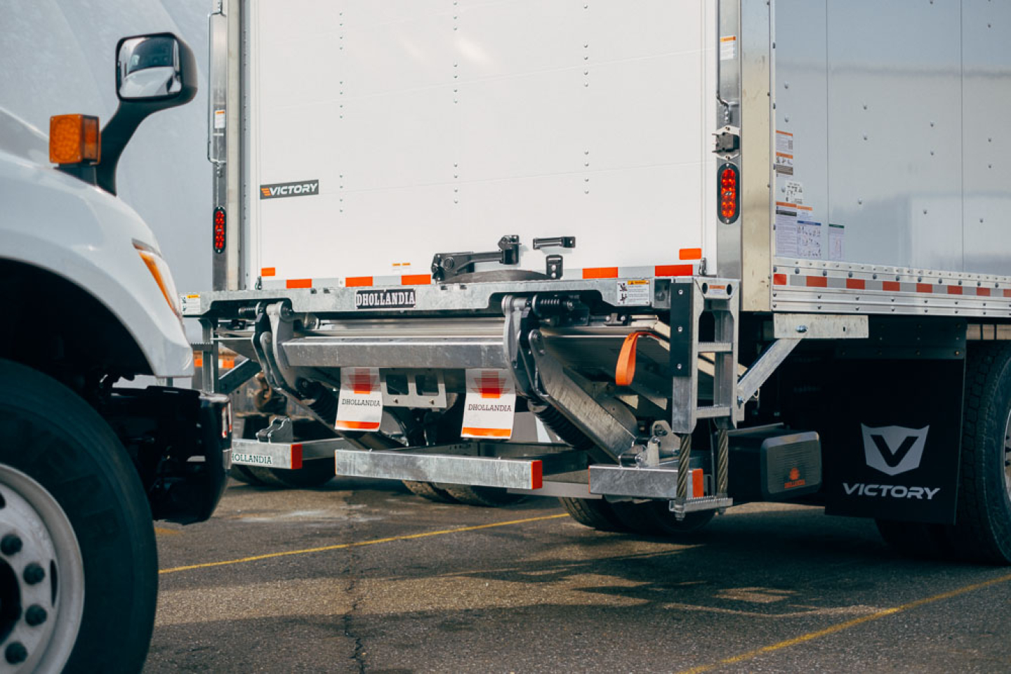 Rear view of a 2025 Mack MD6 box truck showing hitch and rear bumper with Victory branding and reflective tape.