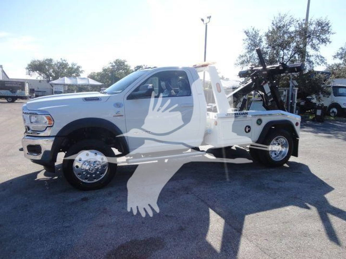 2024 Ram 4500 SLT white pickup tow truck side view showing winch equipment and service bed.