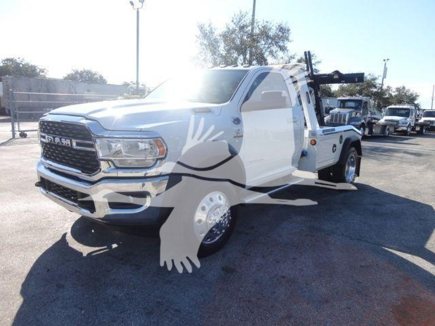 Ram 4500 tow truck with winch equipment front three-quarter view showing Ram grille and heavy-duty front bumper.