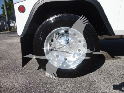 Ram 4500 front wheel and fender area with chrome hubcap, black tire, and partial white body panel; winch category listing context visible.