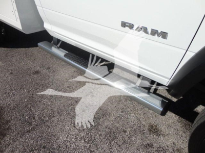 Ram 4500 truck side view showing running board and RAM badge on door panel.