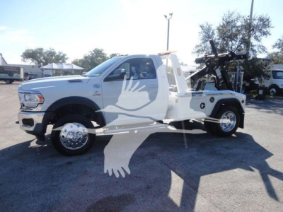 2024 Ram 4500 SLT white pickup tow truck side view showing winch equipment and service bed.
