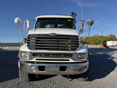 Front view of a white 2006 Sterling LT9500 boom truck showing large grille and bumper.