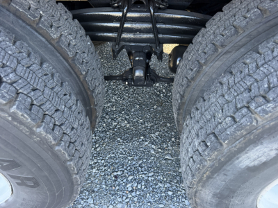ISO twin rear-wheel area of a Sterling LT9500 truck showing dual rear tires, suspension linkage, and drive shaft components visible between the wheels.