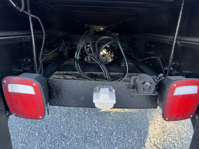 Rear view of a 2006 Sterling LT9500 chassis showing boom area with tangled hydraulic lines and tail lights.