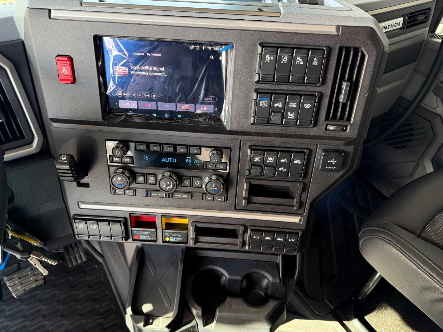 Dashboard of a new 2027 Mack AN64T64 showing touchscreen infotainment, climate controls, and multiple control switches; VIN 1M1A24GY7VM102395 and stock number 72579 in view.