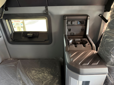 Truck cab interior showing center console and window with labels in a new Mack AN64T64 conventional sleeper.