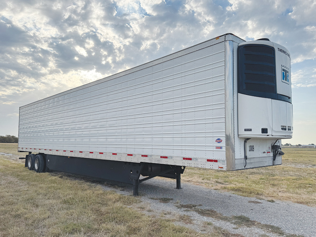 Utility 3000R refrigerated trailer side view showing Thermo King unit at front, white aluminum walls, multiple axles, stock number 558280, VIN SB213350.