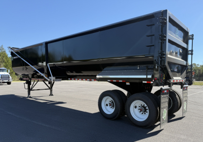 Armor Lite 40x78 scrap trailer in black with dual rear axles and hydraulic dump bed. Side view shows front hitch, ladders, and reflective tape.