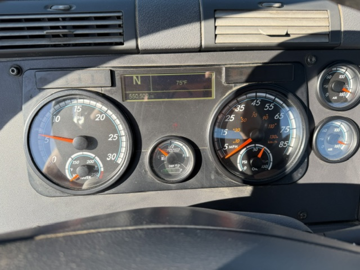 Dashboard view of a 2020 Freightliner Cascadia 125DC with analog gauges, speedometer, tachometer, and digital display showing N and 75°F.