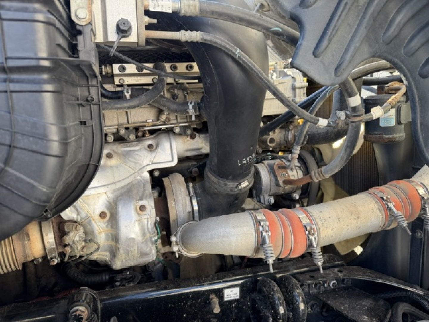 Engine bay of 2020 Freightliner Cascadia 125DC showing intake piping and engine components.