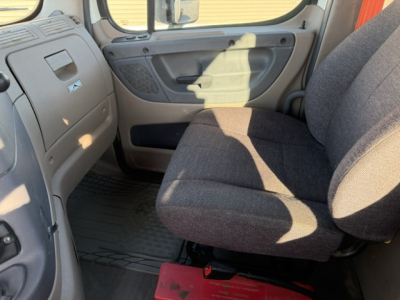 Cab interior of a 2020 Freightliner Cascadia 125DC daycab showing front passenger seat, dashboard, and door trim.