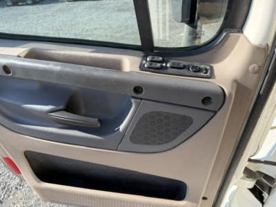 Truck cab interior door panel with window controls visible in a Freightliner Cascadia 125DC auction photo.