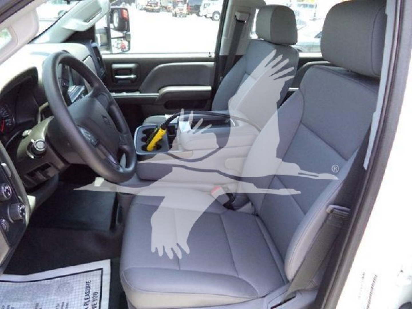 Interior of 2023 International CV truck showing front seats, steering wheel, and dashboard from driver side with watermark
