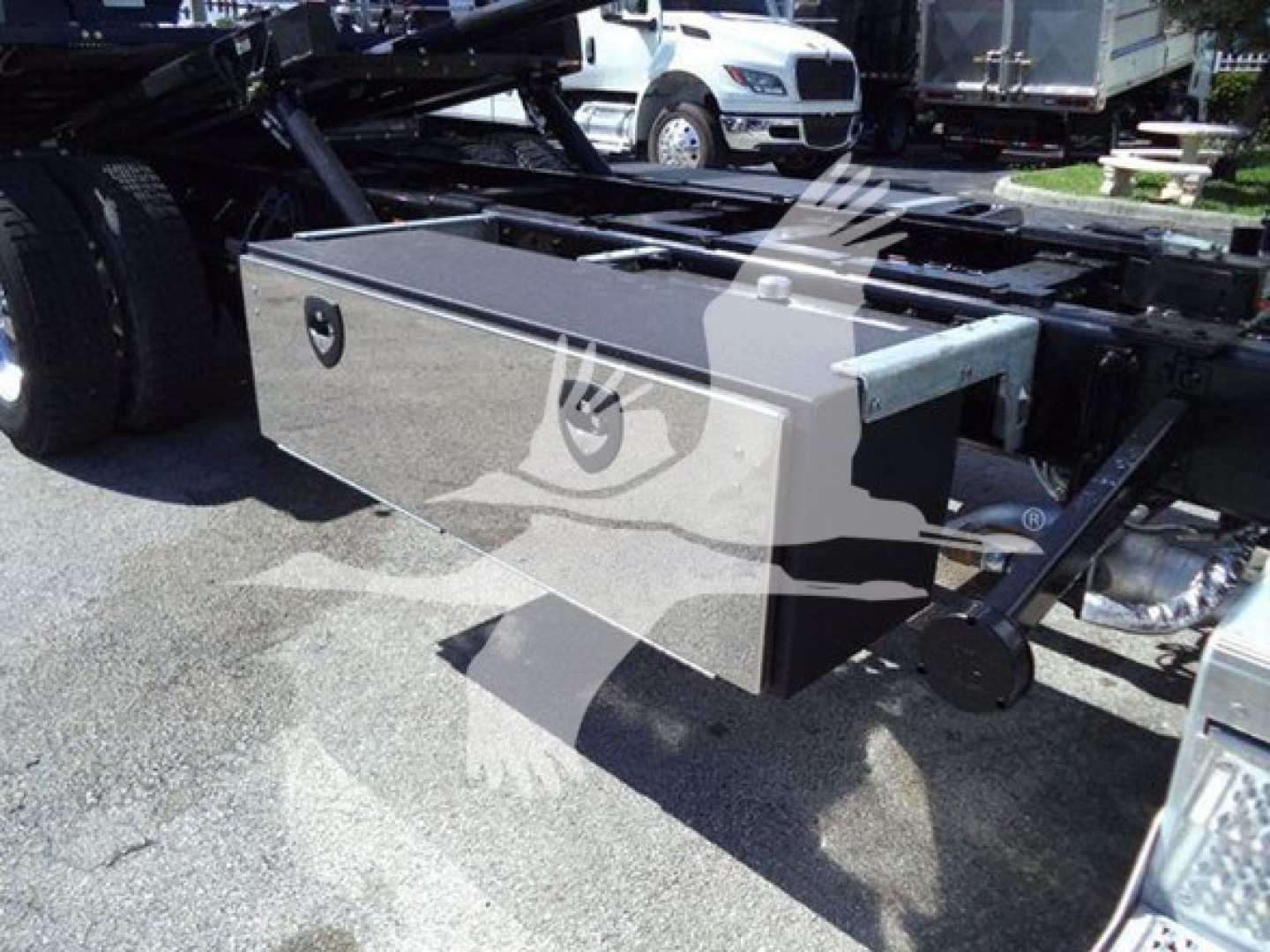 Peterbilt 337 rollback truck chassis showing a metal toolbox mounted under the frame.