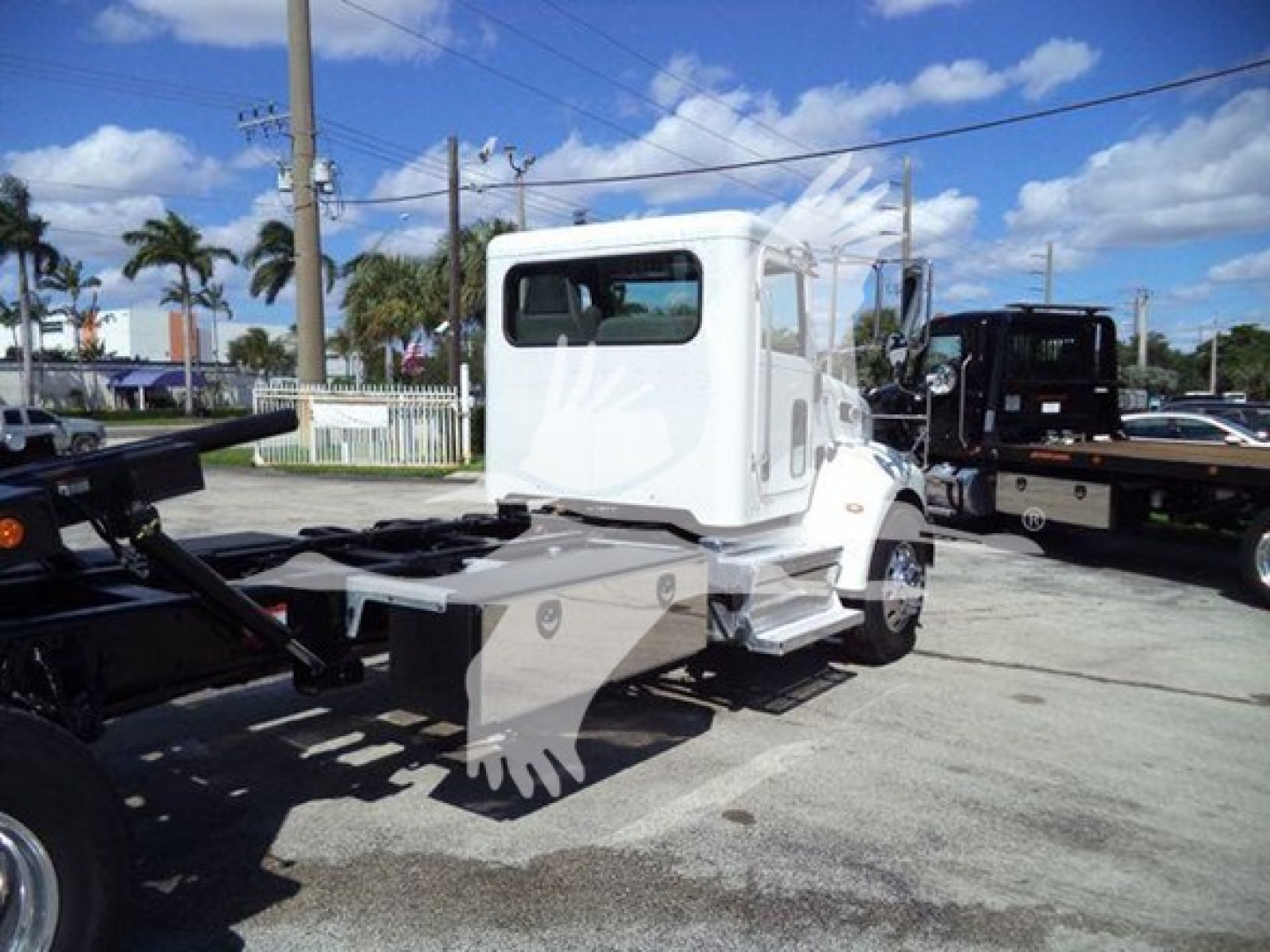Peterbilt 337 rollback truck in white with cab, rear frame and wheelbase view from left side showing chassis and cab.