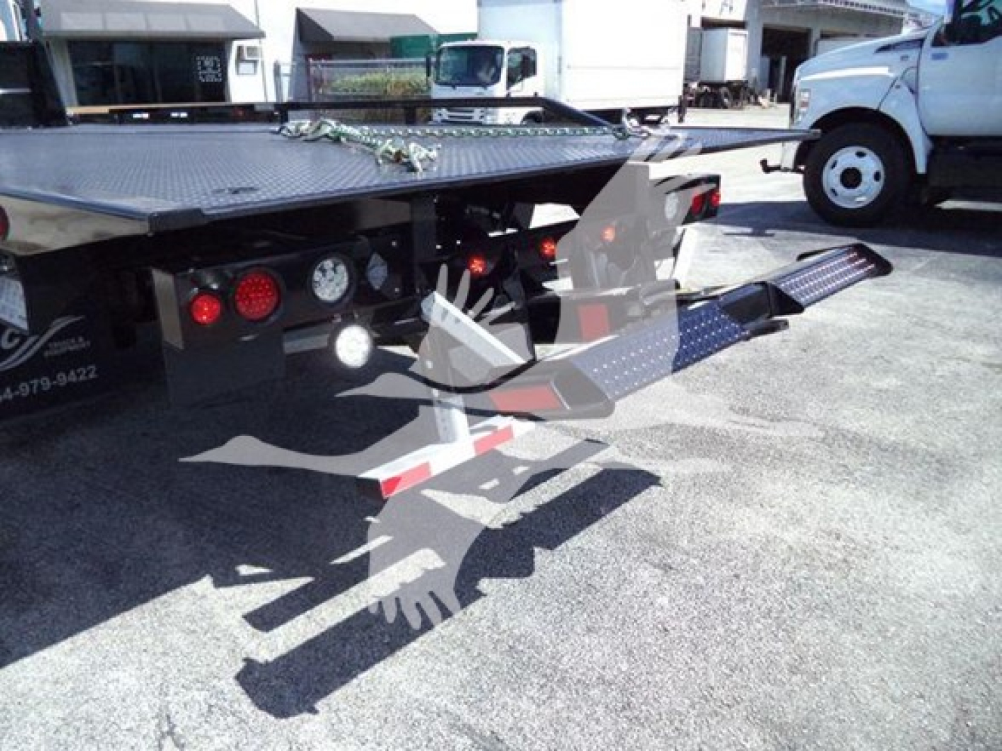 Peterbilt 337 rollback truck rear view showing loading ramp and platform with red lights and step accents.