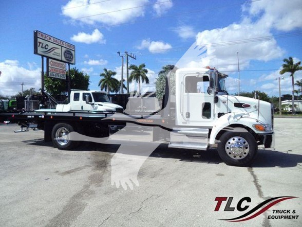 Peterbilt 337 rollback tow truck side profile with white cab and gray flatbed, TLC Truck & Equipment Sales logo visible on ground; palm trees in background.