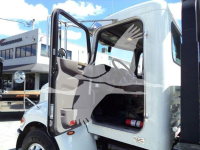Peterbilt 337 cab interior with open door, empty driver seat area, side step, and truck logo visible