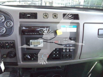 Truck dash area showing Bendix radio, control panel, and gear shifter console in a 2020 Peterbilt 337 rollback interior.
