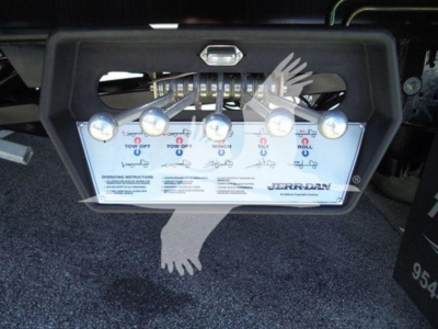 Truck equipment control panel showing multiple levers and labels on a Peterbilt rollback unit, with branded JERR-DAN text visible.