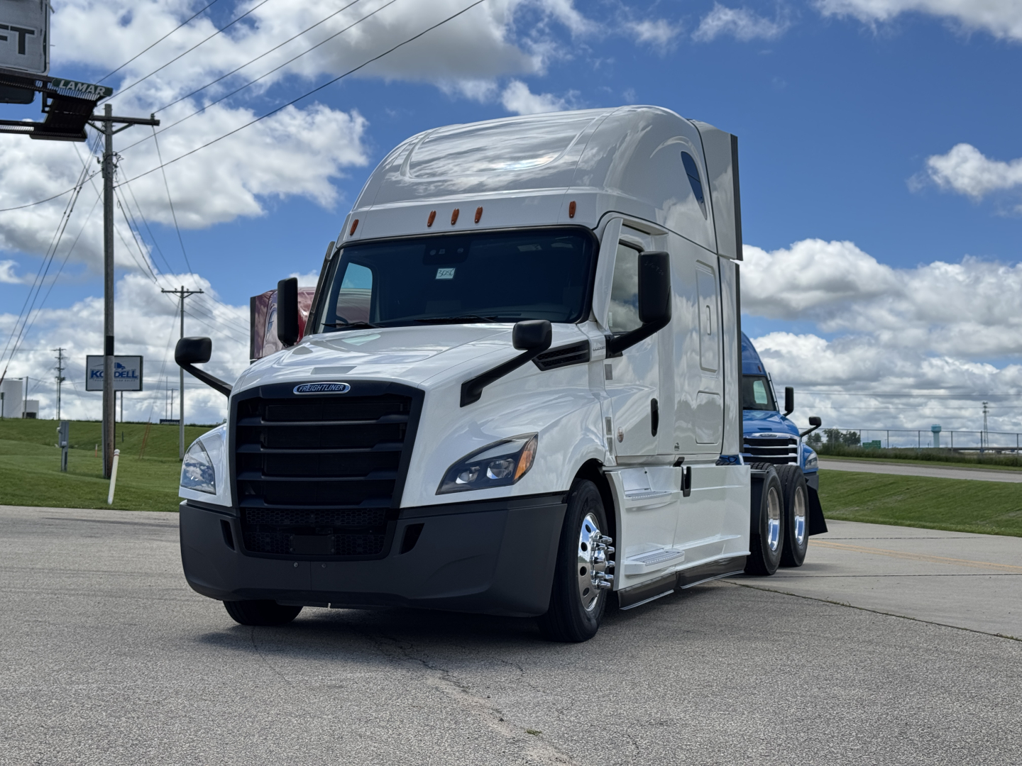 Conventional sleeper truck front-left view of a white 2021 Freightliner Cascadia 126 with high sleeper cab, black grille, and large mirrors.